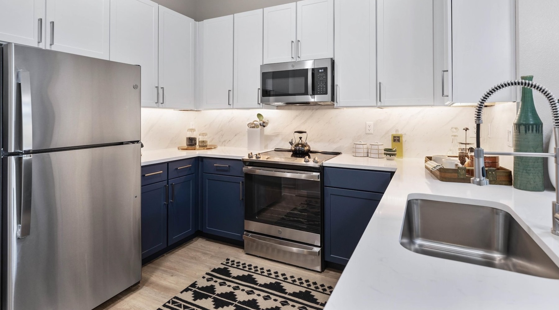 Beautiful kitchens with designer finishes a kitchen with white cabinets and stainless steel appliances