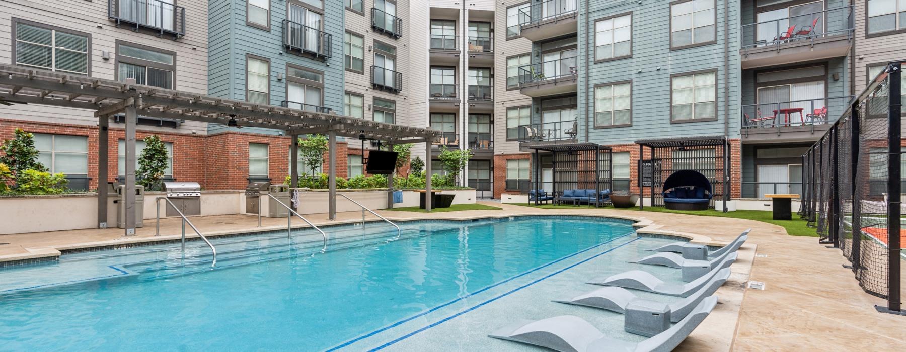a swimming pool in a courtyard between buildings