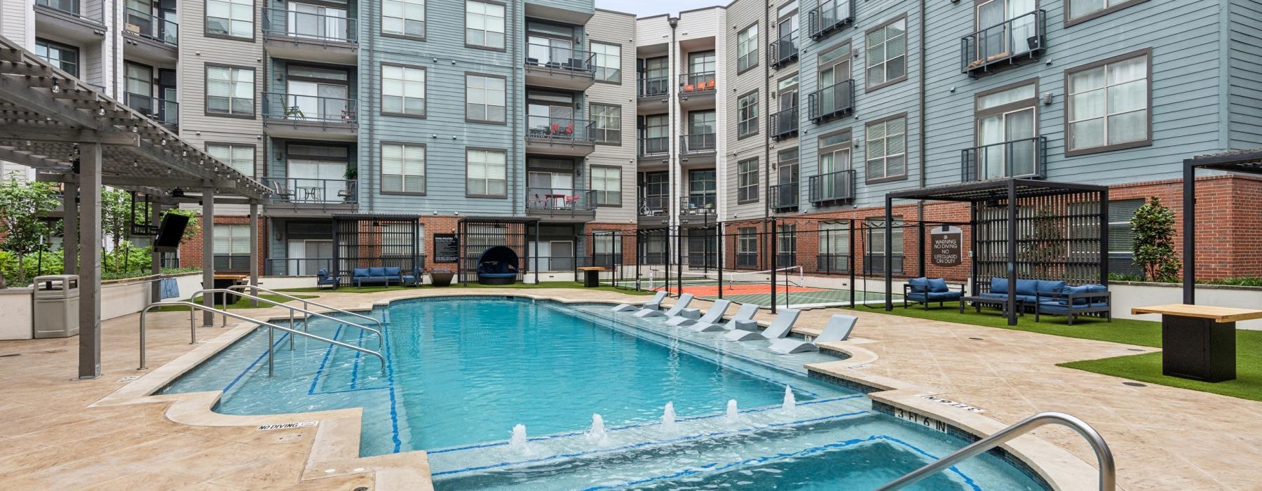 a swimming pool in a courtyard between buildings