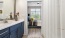 a bathroom with a sink and a bed