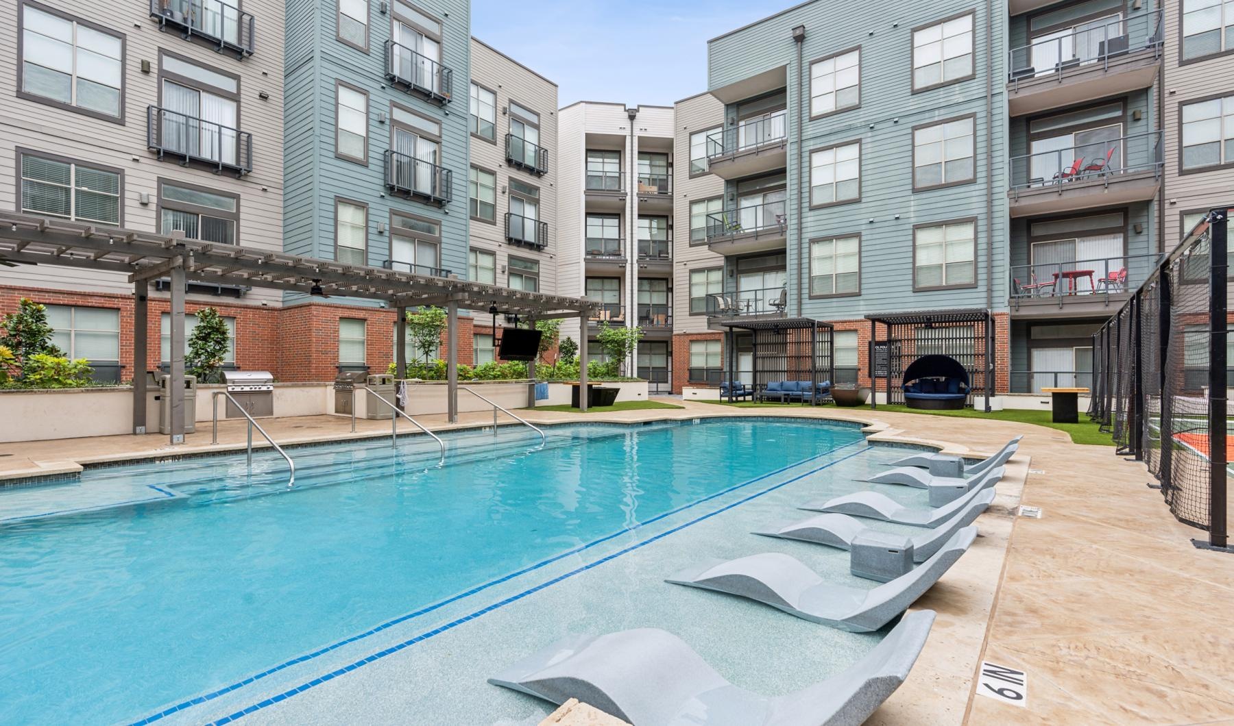 a swimming pool in a courtyard between buildings