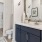 a bathroom with a sink toilet and mirror