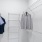 a couple of dresses on a rack in a room with white walls