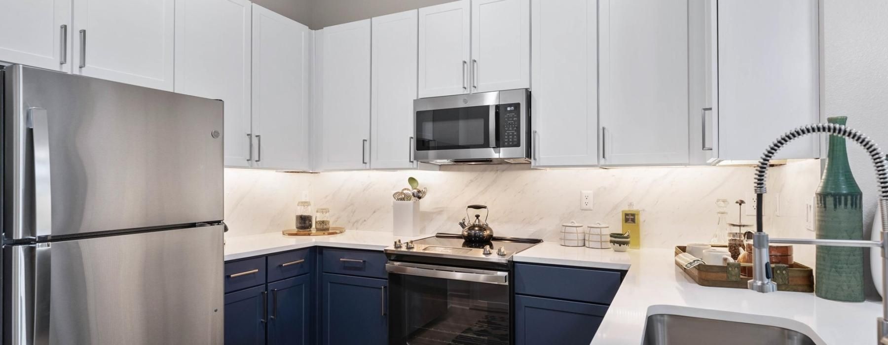 a kitchen with white cabinets