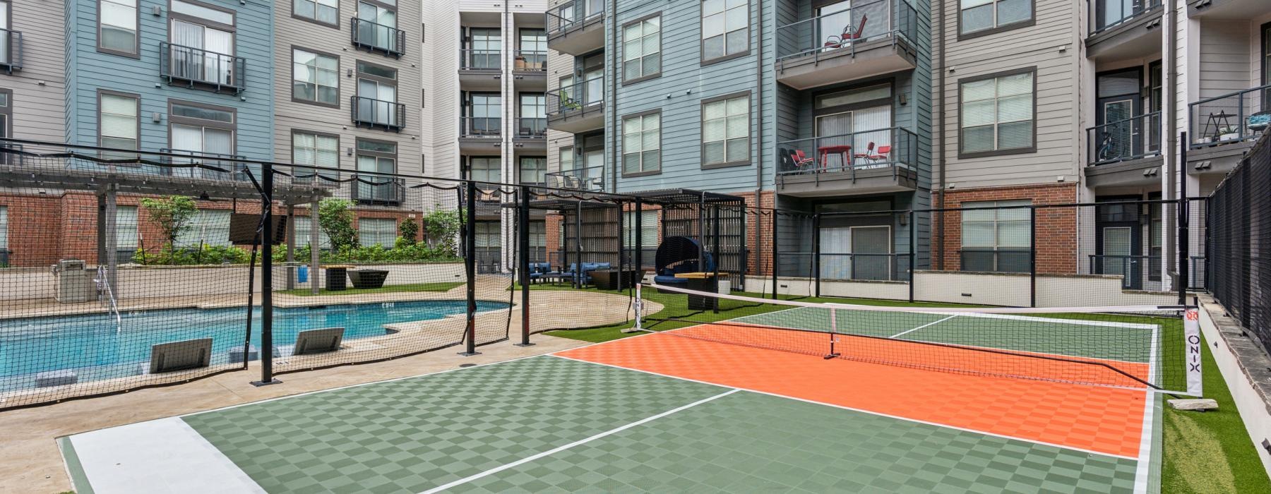 a tennis court in front of a building