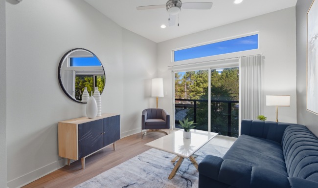 Open living room with couch and large windows Open living room with couch and large windows