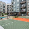 a tennis court next to a pool in a courtyard