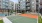 a tennis court in front of a building