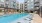 a swimming pool in a courtyard between buildings